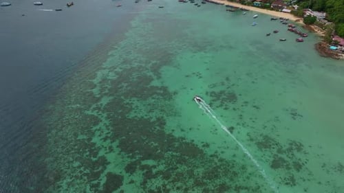 Scenic view of longtail boats on vibrant blue sea, Thailand