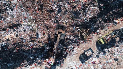 Large Waste Dump and Trash Truck with Garbage in Aerial Top View
