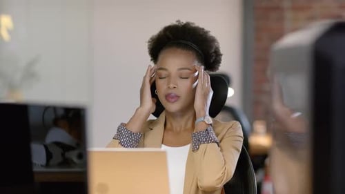 African American businesswoman holding head, feeling stressed