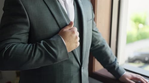 Man in Gray Suit Posing by Window