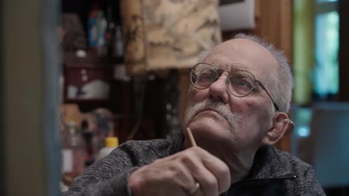 Senior Artist on a Wheelchair Paints an Oil Painting on Canvas in a Studio