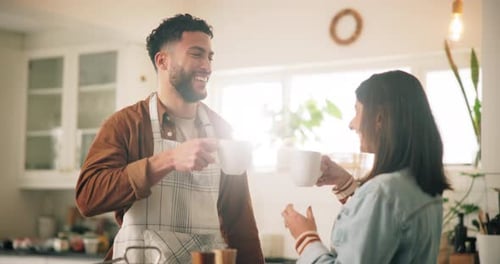 Smiling Couple Cheers with Coffee in Bright Kitchen
