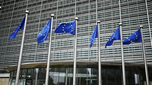 European Union flags waving in front of building