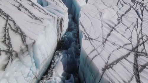 Aerial View of Glacier Crevasse with Blue Water