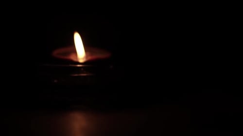 Glowing Diya Lamp Flame in the Darkness