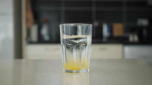 Effervescent Tablet Dissolving in Water in Glass