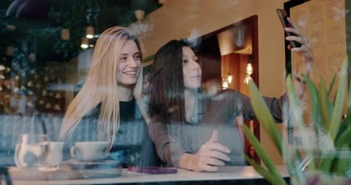 Young Women Taking Selfie in Cafe