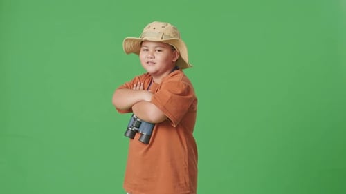 Asian Tourist Boy Researcher Crossing Arms, Smiling On Green Screen Background