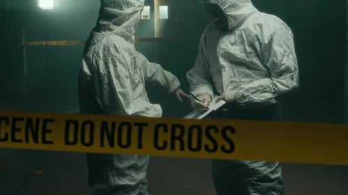 Investigators Examine Crime Scene Indoors at Night