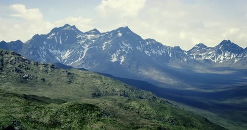 Majestic Mountain Landscape with Lush Greenery and Towering Peaks in Daylight