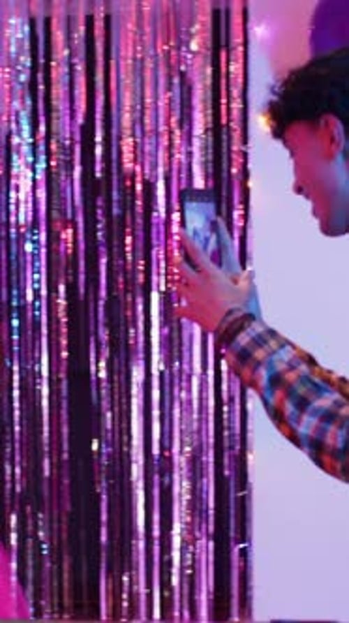 Vertical video: Friends dancing at pool table under disco ball marking Mary's 21st birthday