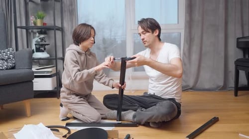Father and Child Assembling Furniture Together at Home