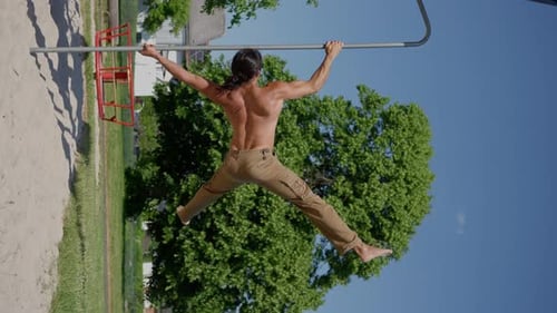 A Handsome Gymnast with a Muscular Torso Performs a Human Flag Vertical Video
