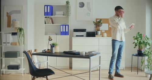 Contemplative Businessman Working On Digita Tablet In Office