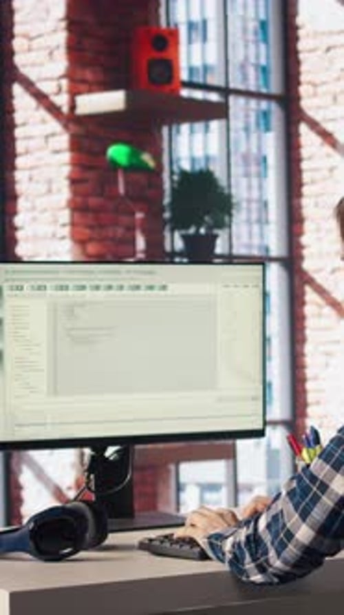 Man at Home Looking at UI on PC Screen Typing and Executing Programming Code