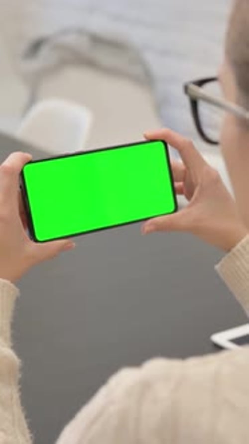 Woman Holding Phone with Green Chroma Key Screen