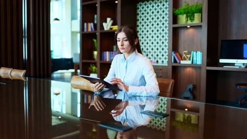Woman Uses Tablet, Smiles in Conference Room