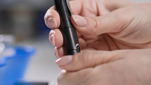 Diabetes Treatment Female Hand Holding Glucometer to Measure Blood Sugar Closeup