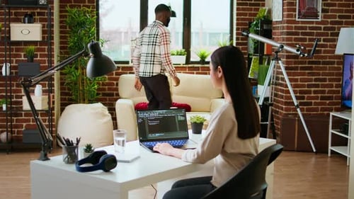 Asian Freelancer Woman Works on Programming Code in a Modern Office