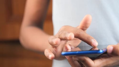Close Up of Young Man Hand Using Smart Phone