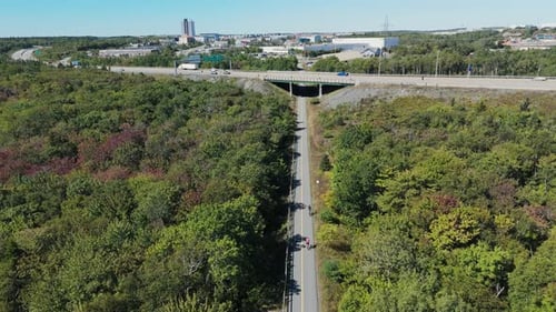 Sporty Woman On Bicycle Riding Through Halifax Park In Summer Aerial Footage