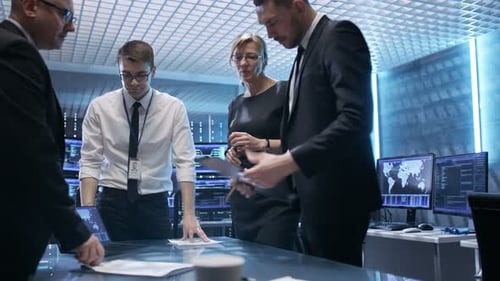Team of Government Agents Tracking Fugitive with Help of Touchscreen Interactive Table in State of