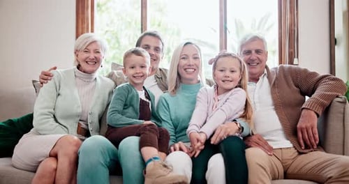 Smiling Family Poses Together on Couch at Home