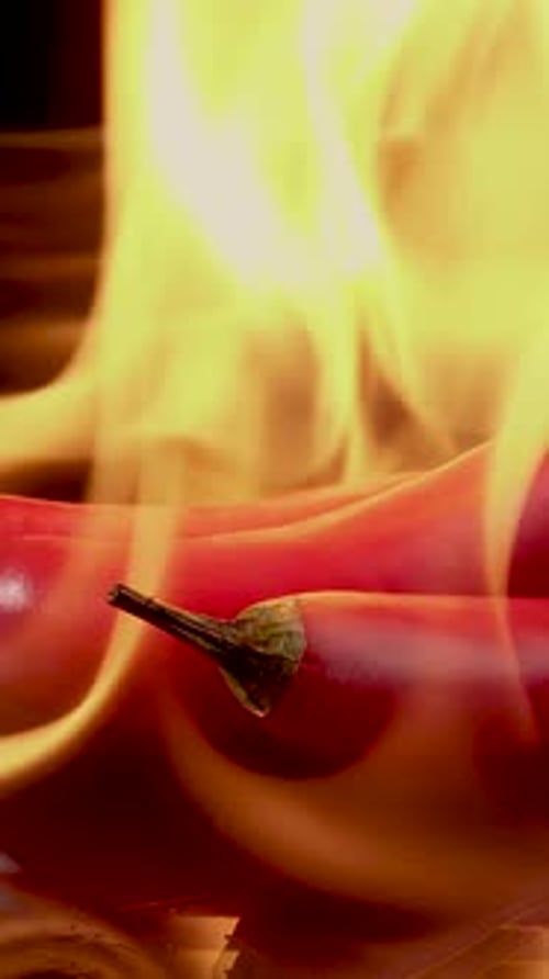 Red Chili Peppers Engulfed in Fiery Flames