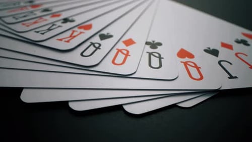 Playing Cards Beautifully Spread on a Dark Surface - Close-Up View
