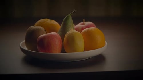 Bowl of Colorful Fruit with Hand Picking Apple