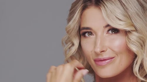 Studio Portrait of Young and Beautiful Blond Woman Over Grey Background Skin Care and Wellness