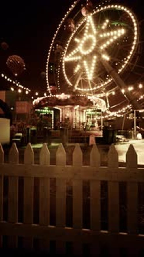 Illuminated Merry Go Round Spinning at Night