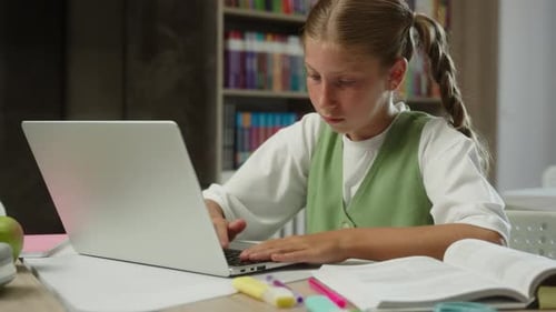Girl Studying with Laptop in School Library