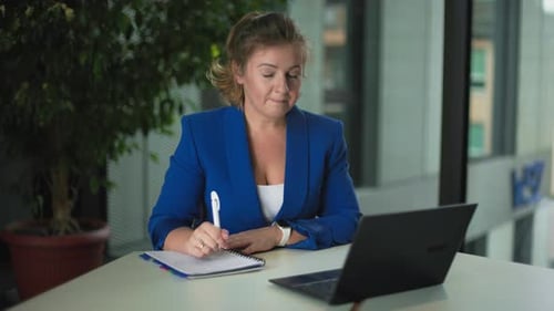 Woman Attends Virtual Meeting in Bright Office