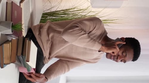 Man Talking on Phone Holding Coffee Cup