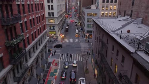 Bustling New York City Street Scene with Traffic Moving Pedestrians Crossing Intersections High Rise