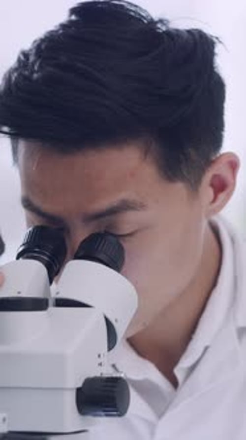 Young Adult Male Scientist Using Microscope Smiling Portrait