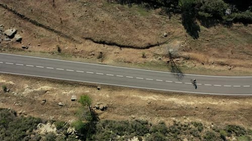 Cyclist Going Up Highway Through The Forest.