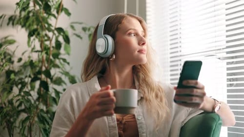 Woman Relaxing With Headphones and Mobile Phone
