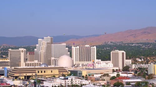 Hot air balloon floats gently over the city of reno Nevada in beautiful light