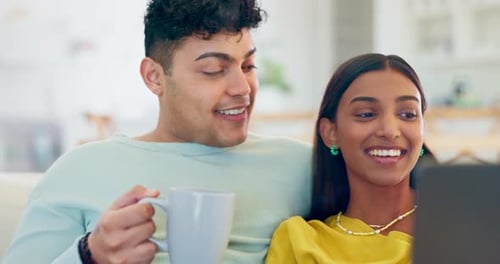 Affectionate Couple Relaxing at Home with Laptop