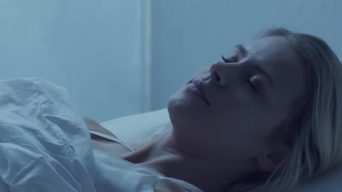 Woman Resting Comfortably in Bed at Night