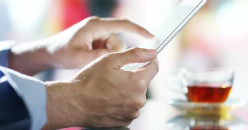 hand typing and touching tablet in a moment of relaxation in slow motion