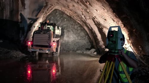 Surveyor Using Total Station in an Underground Tunnel Construction Site