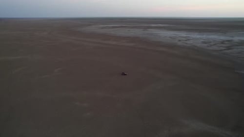 Aerial view of mud flats with car, Australia.