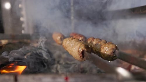Close Up of Sizzling Kebab Cooking Over Coals