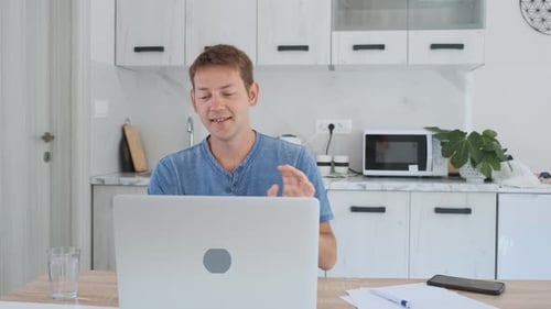 Man Talking During Video Call On Laptop At Home