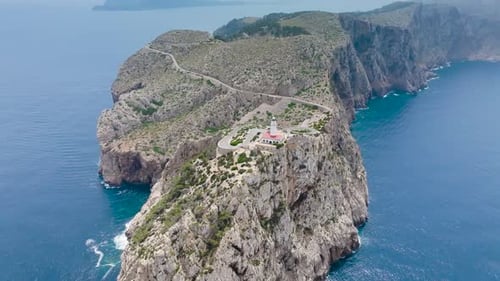 Lighthouse tower on rugged limestone cape