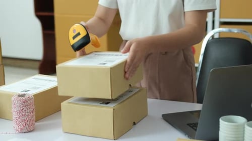 Scanning Packages for Delivery at Shipping Workstation