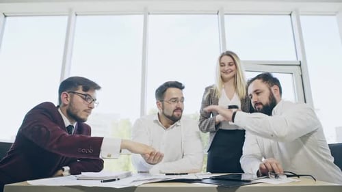 Team Celebrates Business Achievement in Bright Office